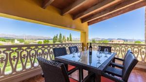 a balcony with a table with wine glasses on it at Villa Son Fanals in Alcudia +47 photos