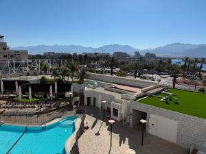 a view of a swimming pool at a resort at sea&sky luxury suite מילה דירות אירוח in Eilat