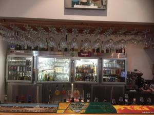 a bar with many wine glasses on the wall at Springsure Overlander Motel in Springsure