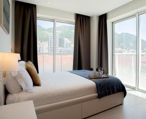 a bedroom with a bed with a large window at West One - Luggage Facility Available in Gibraltar +31 photos
