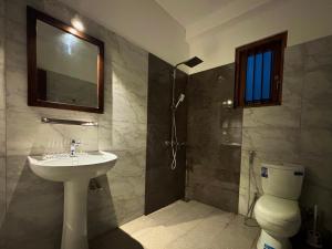a bathroom with a sink and a shower and a toilet at Hotel Dreamliners in Katunayaka +21 photos