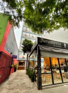 a store with a sign on the front of a building at Hotel Juramento in Buenos Aires +3 photos