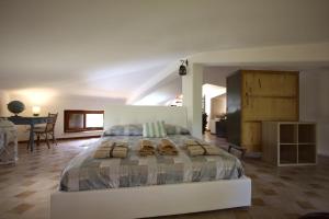 a bedroom with a large bed with sandals on it at Stanza del Cerro in Aranova