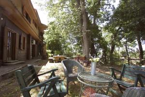 an outdoor table and chairs with a vase on it at Stanza del Cerro in Aranova