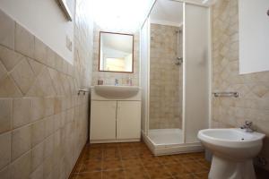 a bathroom with a sink and a toilet and a shower at Stanza dell'Ulivo in Aranova