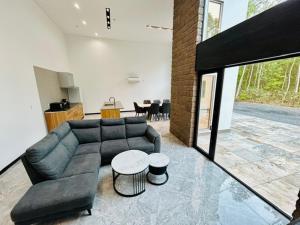 a living room with a couch and a table at White Chalet Niseko in Niseko +29 photos
