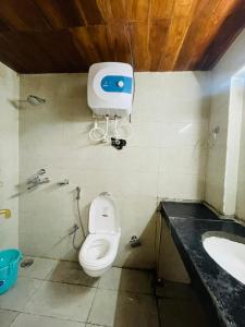 a bathroom with a toilet and a sink at Kedarnath Aastha Path ME5 Building in Kedārnāth