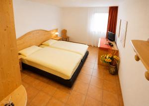 a bedroom with a bed and a television in it at Hotel-Aparthotel San Bernardino in San Bernardino +38 photos