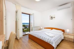 a bedroom with a bed and a large window at Rooms Vera in Porat