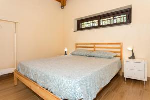 a bedroom with a bed and a window at Casetta delle Rose sull'etna in Viagrande