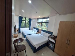 a bedroom with a bed and a desk and a chair at Galaxy Villa Tam Đảo in Tam Ðảo
