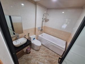 a bathroom with a sink and a tub and a toilet at Galaxy Villa Tam Đảo in Tam Ðảo