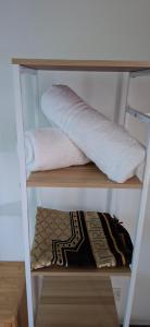 a shelf with two towels on top at Twenty2 Homestay Sepang in Sepang