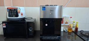 a coffee maker sitting on top of a microwave at Twenty2 Homestay Sepang in Sepang