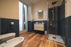 a bathroom with a toilet and a sink and a shower at Corso52 B&B in Monte Libretti +9 photos