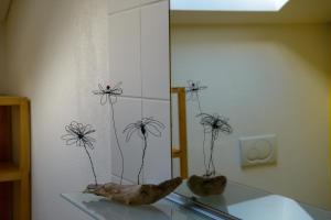 two vases with flowers on top of a glass table at Ostello Cresciano in Cresciano