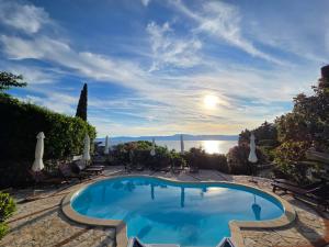a swimming pool with a view of the water at Apartments Villa Dora in Kraljevica