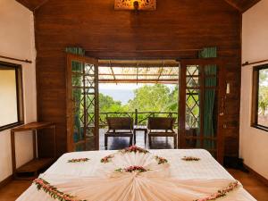 a bedroom with a bed with an umbrella on it at Ting Rai Bay Resort in Ko Jum