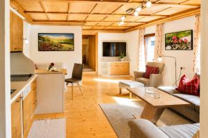 a living room with a couch and a table at Landhaus Trinker in Schladming