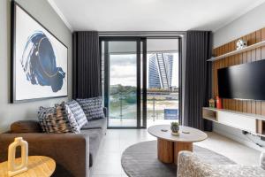 a living room with a couch and a tv at Lux @ Ellipse Galelileo in Midrand