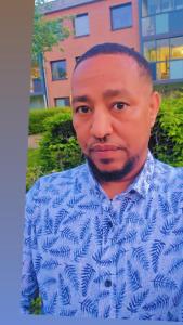 a man wearing a blue shirt and tie at Isayas Asfehale Welday in Halmstad