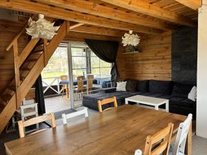 a living room with a table and a couch at Šarkos sodyba in Miežonys