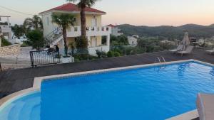 a swimming pool in front of a house at Diogenis Parga Studios in Parga +45 photos