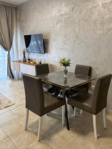 a dining room with a black table and chairs at Apartments Sofia in Kotor