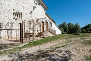 a brick building with a gate next to a yard at La Campana d'Oro Bibbiena in Bibbiena +34 photos