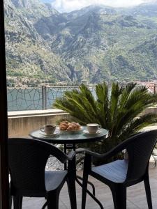 a table and chairs with a view of a mountain at Apartments Sofia in Kotor
