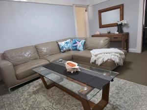 a living room with a couch and a table at The Red Manor on Mort in Lithgow +2 photos