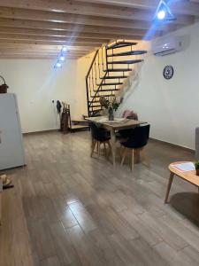 a dining room with a table and a staircase at Mary's home in Atsikí +12 photos