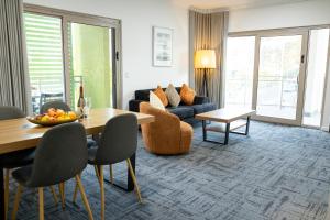 a living room with a couch and a table at Baileys Serviced Apartments in Perth