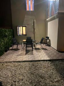 a patio with chairs and a table in a building at Mary's home in Atsikí