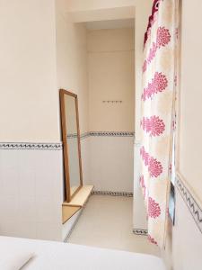 a bathroom with a mirror and a shower curtain at Hotel Shree Jay Amba Deluxe in Jaisingpur +26 photos