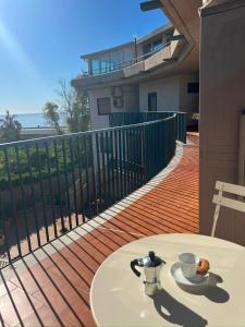 a table with a cup of coffee on a balcony at DaMa s Apartment on the beach in Giardini Naxos