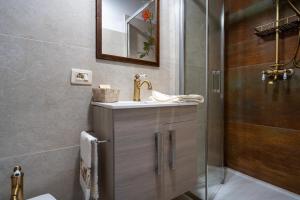 a bathroom with a sink and a shower at La Campana d'Oro Bibbiena in Bibbiena