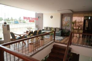 a living room with a table and chairs at Vilasini Inn in Maddūr