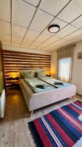 a bedroom with a bed and a rug in a room at Vista Verde - Private house with 3 bedrooms & 3 bathrooms in Oreshak