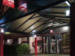 a building with awning over the entrance to a store at ibis Douala in Douala
