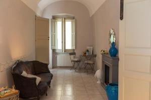 a living room with a leather chair and a table at Nel Blu Dipinto di Blu - Casa Anemone in Polignano a Mare