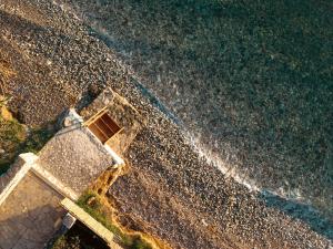 an aerial view of a building next to the ocean at IoMi Terra & Mare in Eleonas