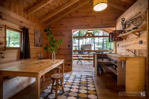 a kitchen with a large wooden table in a cabin at Camping Osenbach in Osenbach