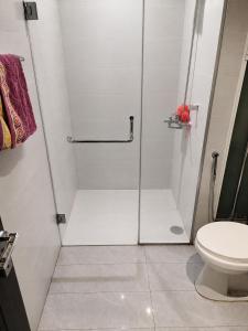 a bathroom with a shower and a toilet at Zameen Opal Executive 2-Bed Suite in Lahore
