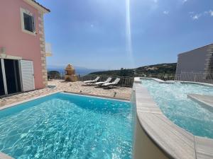 a swimming pool with a view of the ocean at Villa Kaminia Rose private pool & Jacuzzi in Ratzaklíon