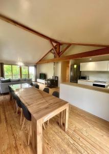 a large dining room with a wooden table and chairs at Chalet 6 personnes ou studio 2 personnes in Ax-les-Thermes