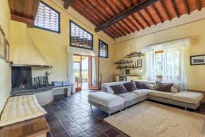 a living room with a couch and a fireplace at Agriturismo Montechiaro in Siena