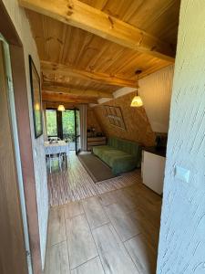 a living room with a couch and a table at Domki Brzozowy Zakątek in Sochy