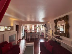 a living room with a couch and a dining room at Red Flat Paris in Paris