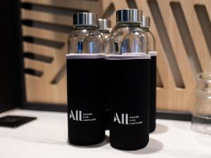 two bottles of water sitting on top of a table at Mercure Lorient Centre in Lorient